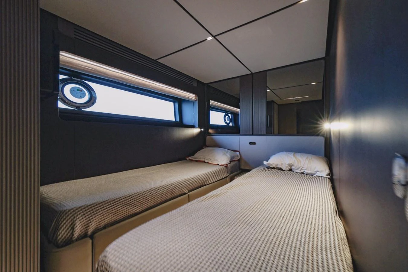A cozy twin stateroom featuring modern design and ample natural light. aboard SEA SAKURA Yacht for Sale
