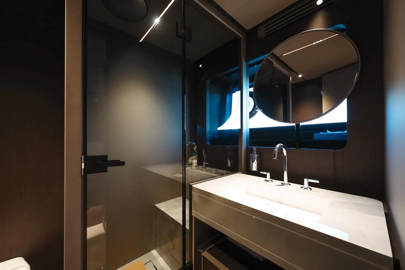 A sleek and modern bathroom with a large mirror and dual sinks. aboard SEA SAKURA Yacht for Sale