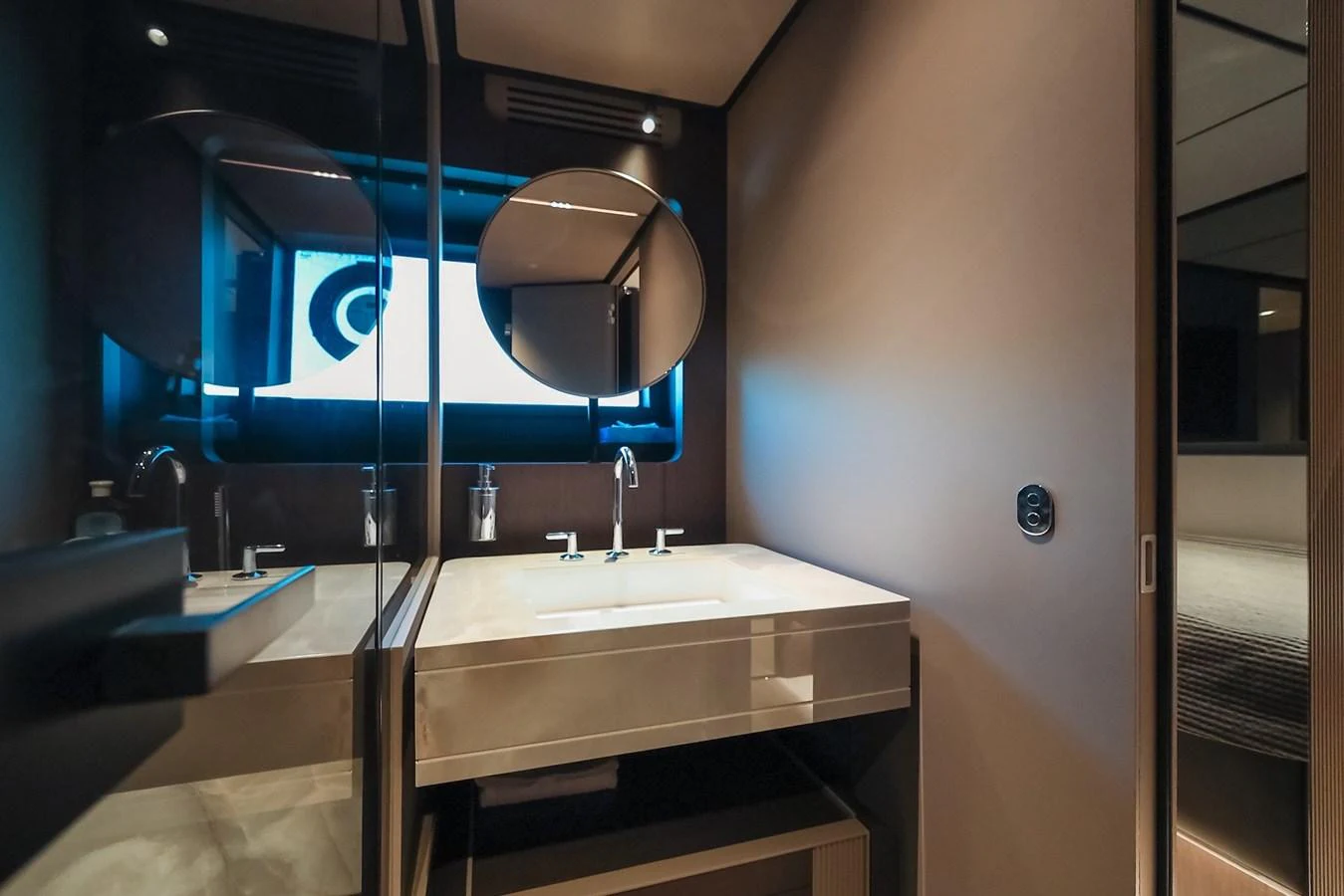 A sleek and modern bathroom with a large mirror and stylish fixtures. aboard SEA SAKURA Yacht for Sale