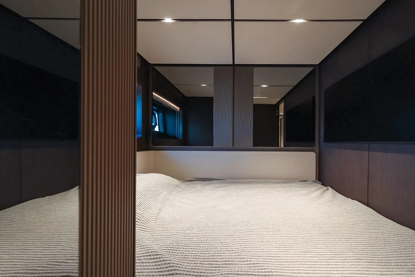 The stateroom features a spacious bed with modern, minimalist decor. aboard SEA SAKURA Yacht for Sale
