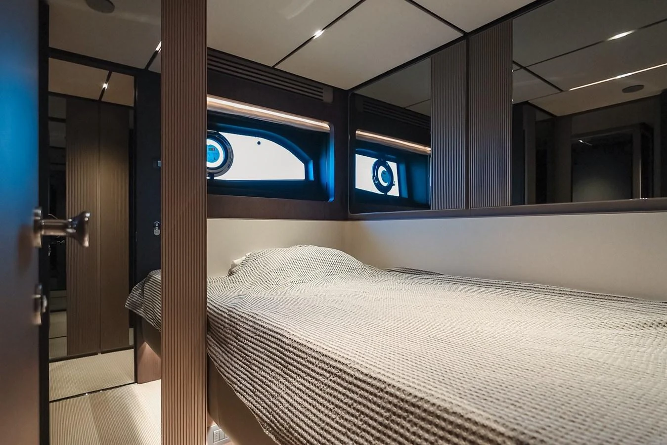 A cozy guest stateroom with a large bed and modern decor. aboard SEA SAKURA Yacht for Sale