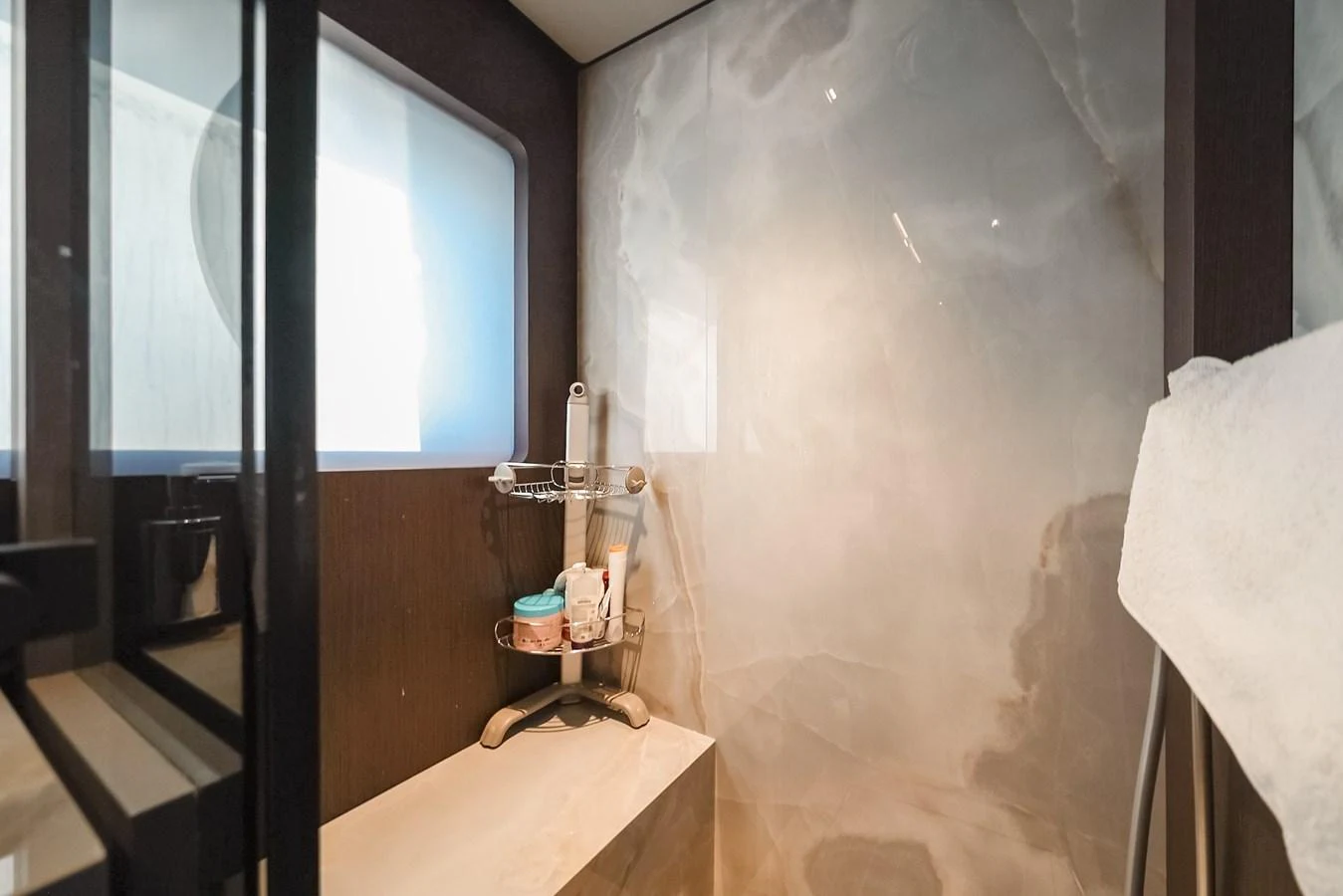 The yacht's bathroom features a sleek and modern design with a luxurious shower area. aboard SEA SAKURA Yacht for Sale