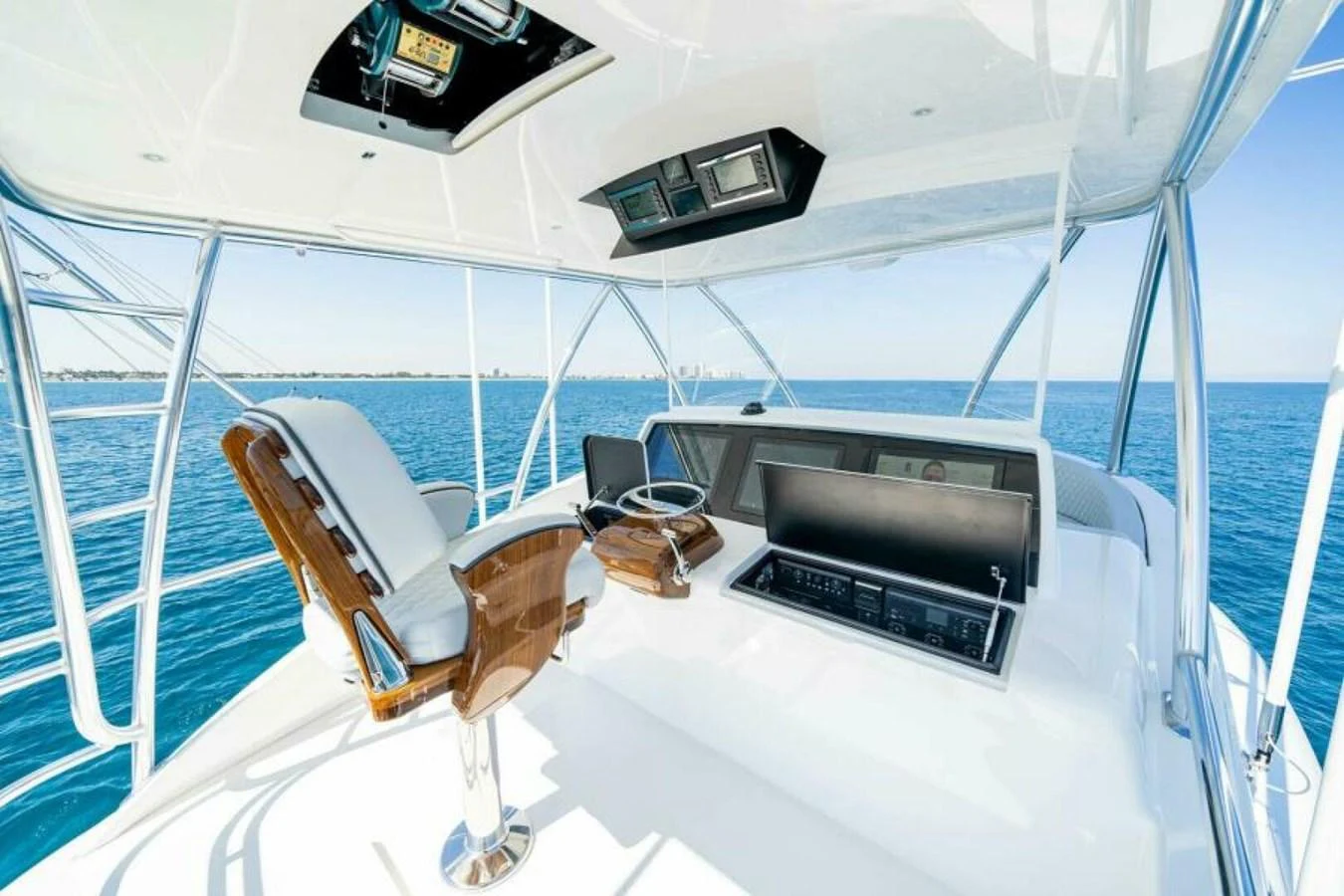 The helm station offers a commanding view of the open sea with state-of-the-art navigation equipment. aboard 2027 VIKING 90SB Yacht for Sale