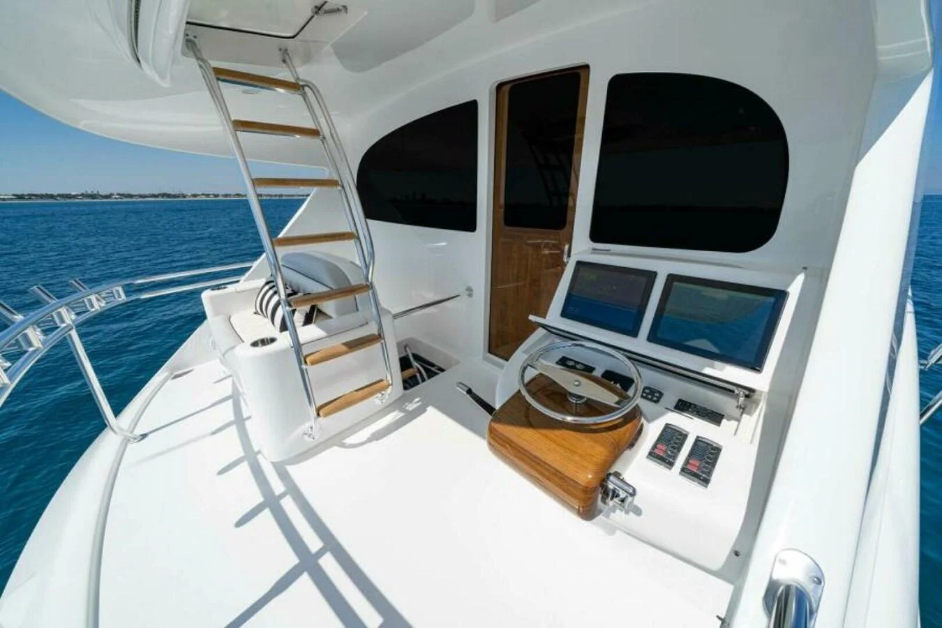 The flybridge offers a commanding view with modern navigation equipment and comfortable seating. aboard 2027 VIKING 90SB Yacht for Sale