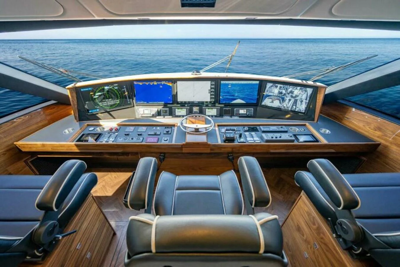 The helm station offers a commanding view with state-of-the-art navigation equipment and luxurious seating. aboard 2027 VIKING 90SB Yacht for Sale