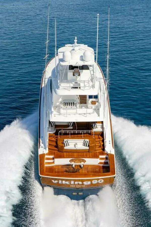 A stunning yacht cruises through the water, showcasing its sleek design and powerful performance. aboard 2027 VIKING 90SB Yacht for Sale