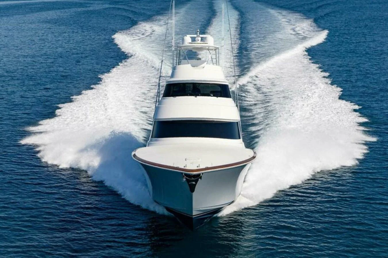 A sleek yacht cuts through the water, showcasing its impressive speed and design. aboard 2027 VIKING 90SB Yacht for Sale
