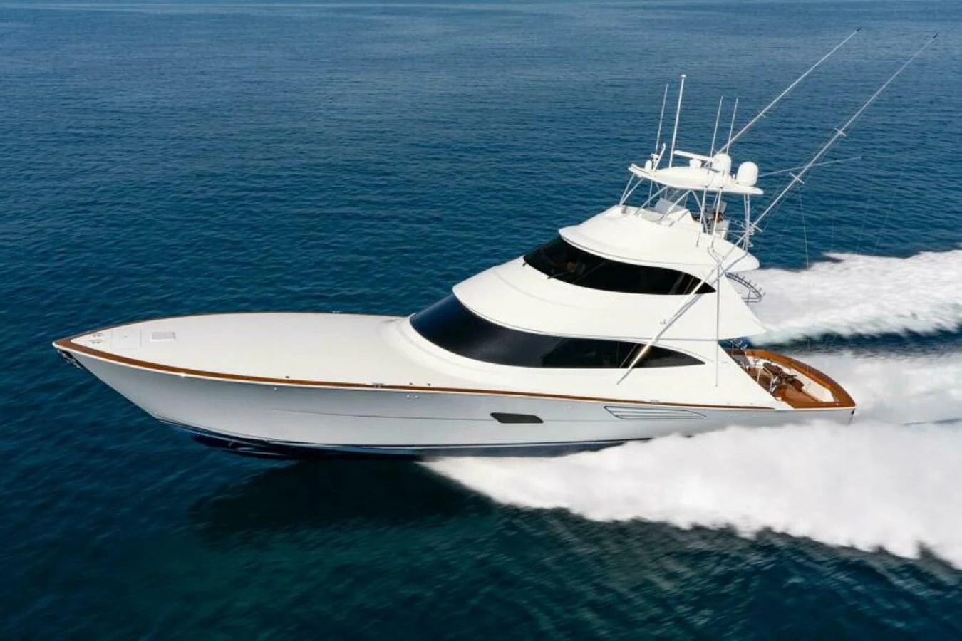 A sleek and modern yacht cruises swiftly across the open water. aboard 2027 VIKING 90SB Yacht for Sale