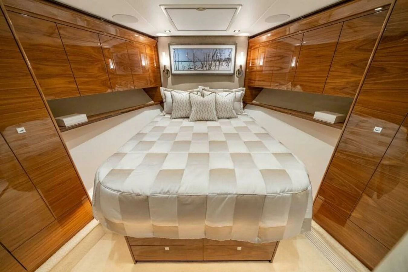 The stateroom features a luxurious bed with elegant wood paneling and ample storage. aboard 2027 VIKING 90C Yacht for Sale