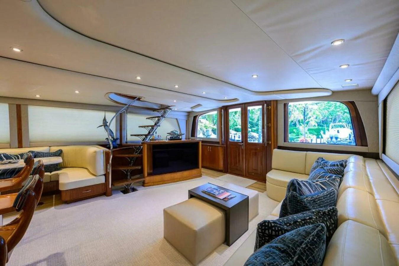 The salon offers a spacious and luxurious seating area with ample natural light. aboard JUNIOR Yacht for Sale