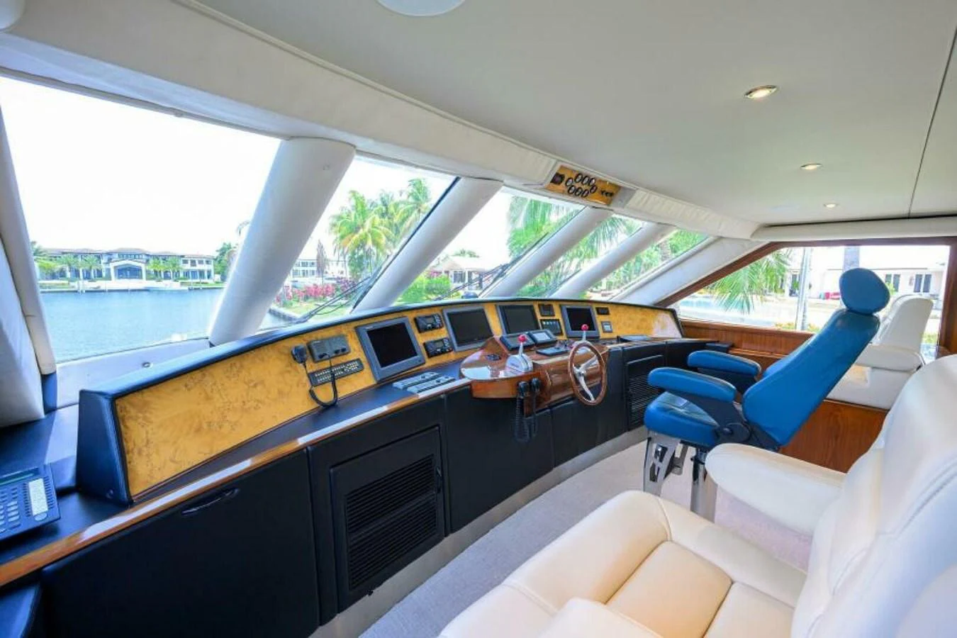 The helm station features a panoramic view with luxurious seating and advanced navigation equipment. aboard JUNIOR Yacht for Sale