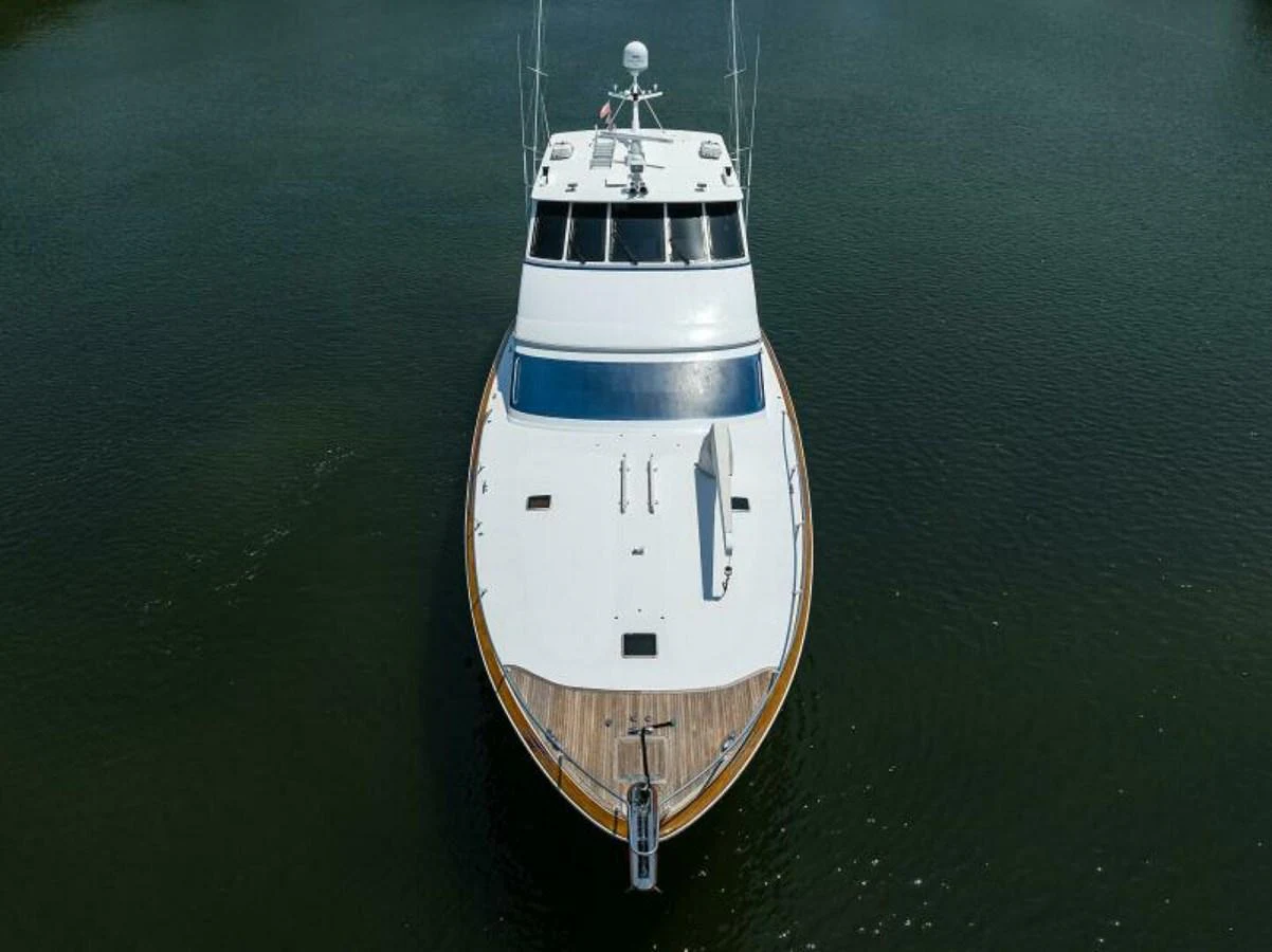 A sleek yacht is captured from an aerial view, showcasing its pristine deck and modern design. aboard JUNIOR Yacht for Sale