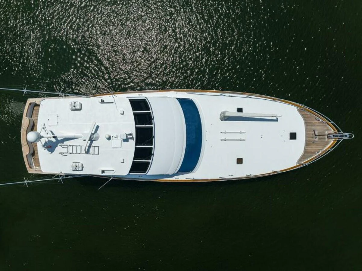 Aerial view of a sleek yacht cruising on calm waters. aboard JUNIOR Yacht for Sale