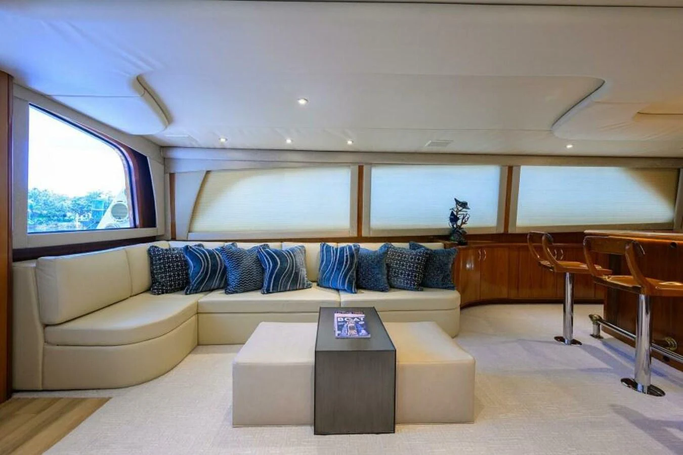 The salon features a comfortable seating area with plush cushions and a modern coffee table. aboard JUNIOR Yacht for Sale