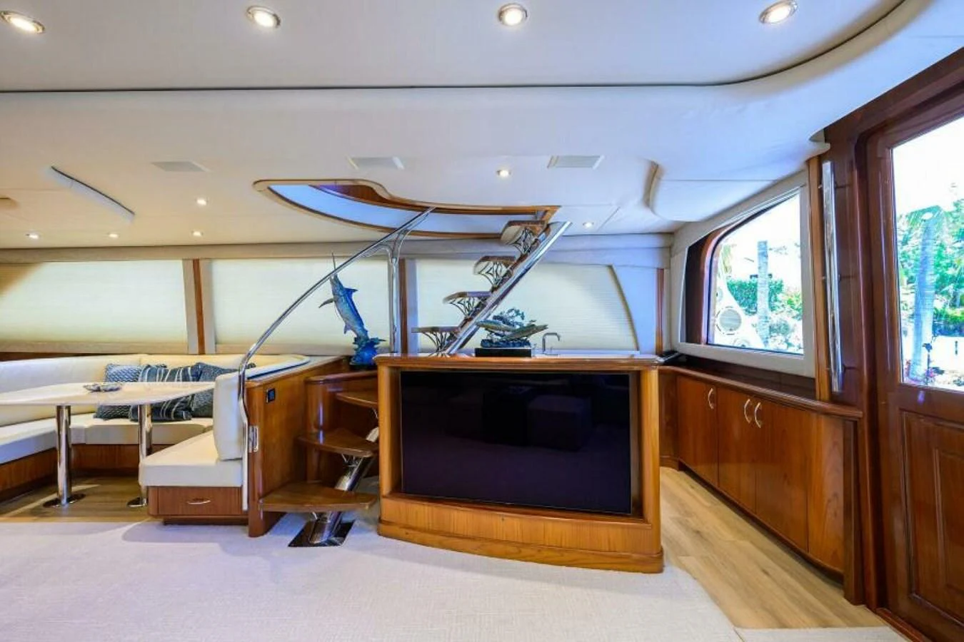 The yacht's salon features elegant wood finishes and ample seating. aboard JUNIOR Yacht for Sale
