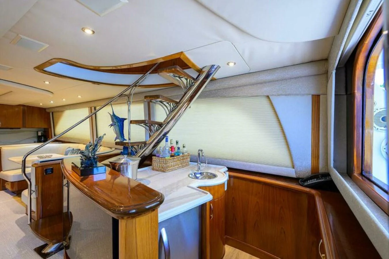 The yacht's galley features elegant wood finishes and modern amenities. aboard JUNIOR Yacht for Sale