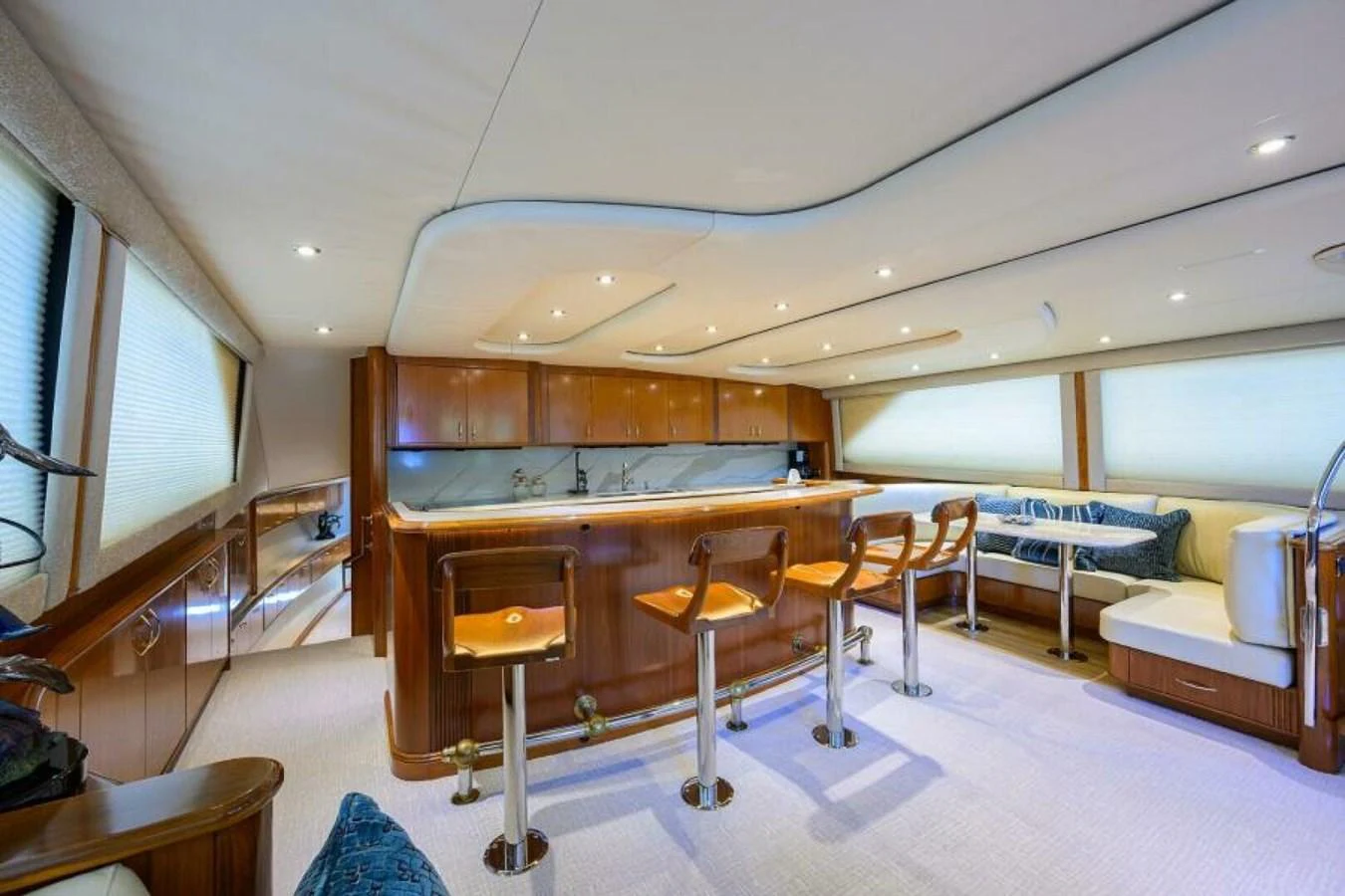 The yacht's galley features a spacious and well-lit area with a bar and comfortable seating. aboard JUNIOR Yacht for Sale