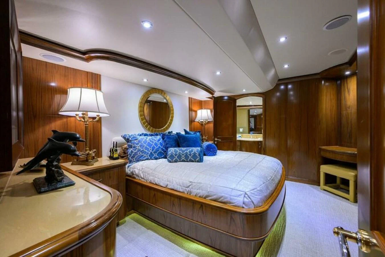 A luxurious stateroom featuring elegant wood paneling and plush bedding. aboard JUNIOR Yacht for Sale
