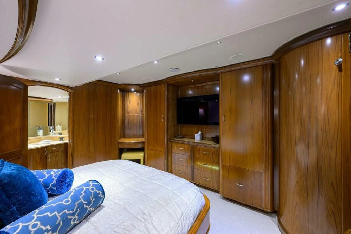 The stateroom features luxurious wood paneling, a comfortable bed, and a flat-screen TV for ultimate relaxation. aboard JUNIOR Yacht for Sale
