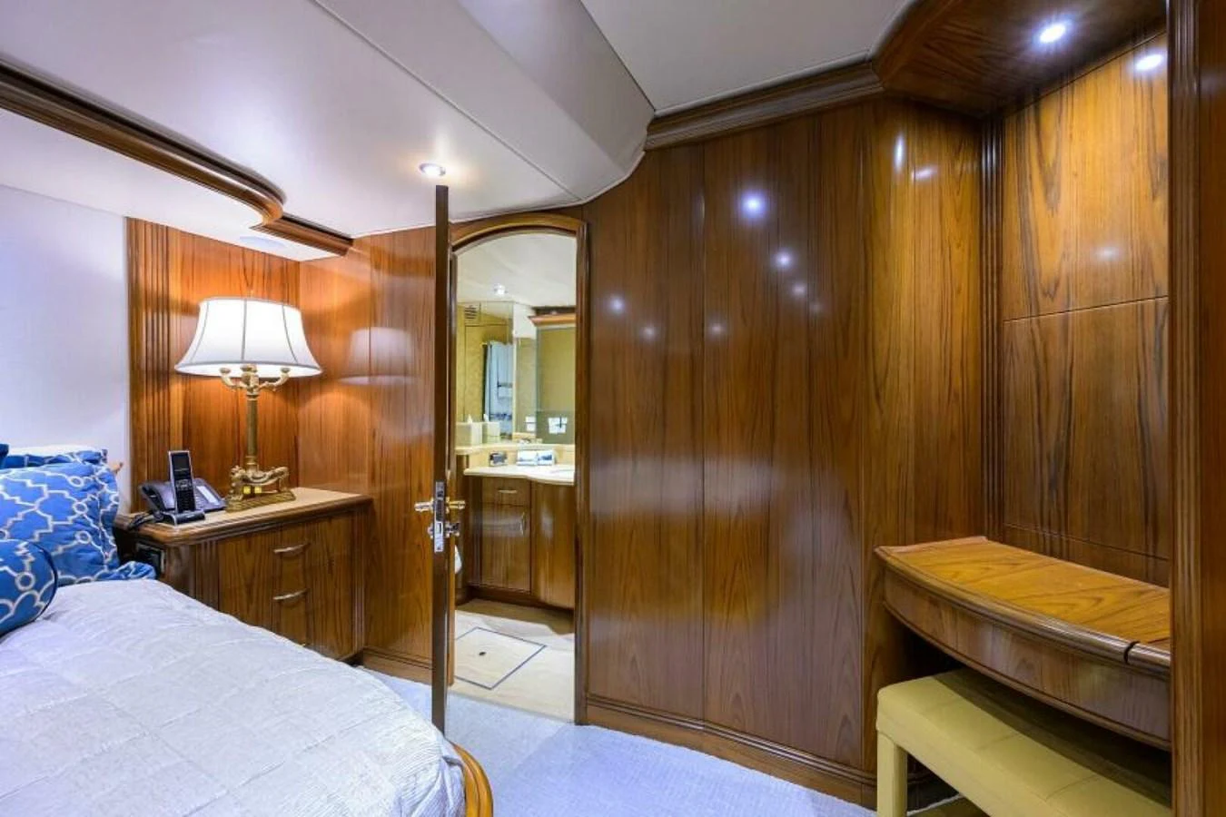 The stateroom features elegant wood paneling and a cozy ambiance. aboard JUNIOR Yacht for Sale