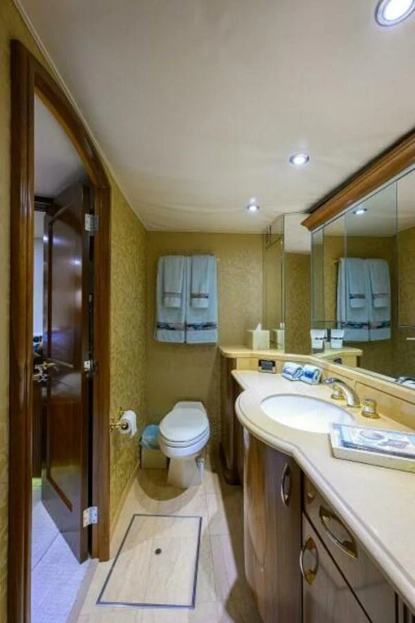 The yacht's bathroom features elegant fixtures and a spacious countertop. aboard JUNIOR Yacht for Sale