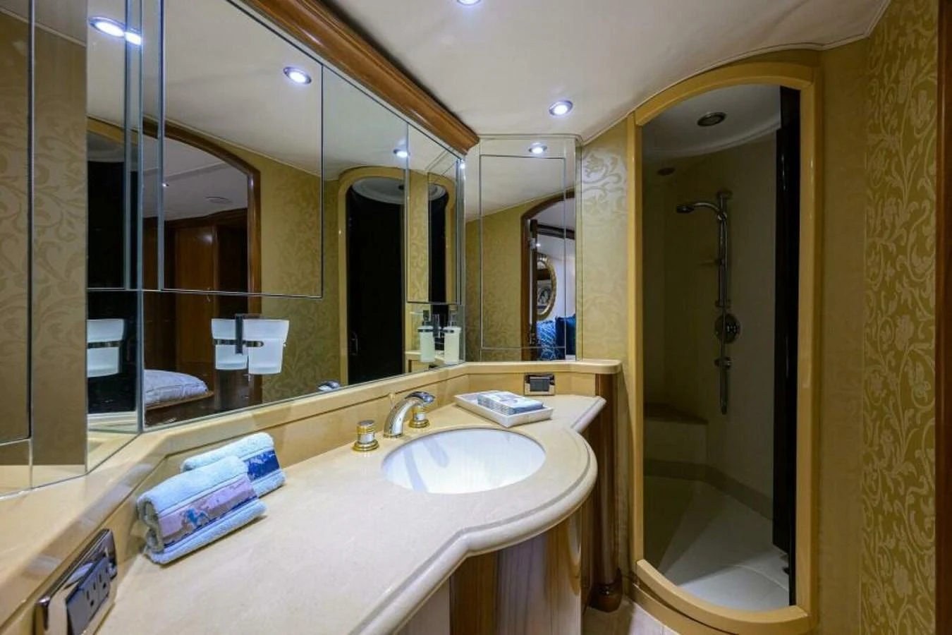 The yacht's bathroom features elegant fixtures and a spacious shower area. aboard JUNIOR Yacht for Sale