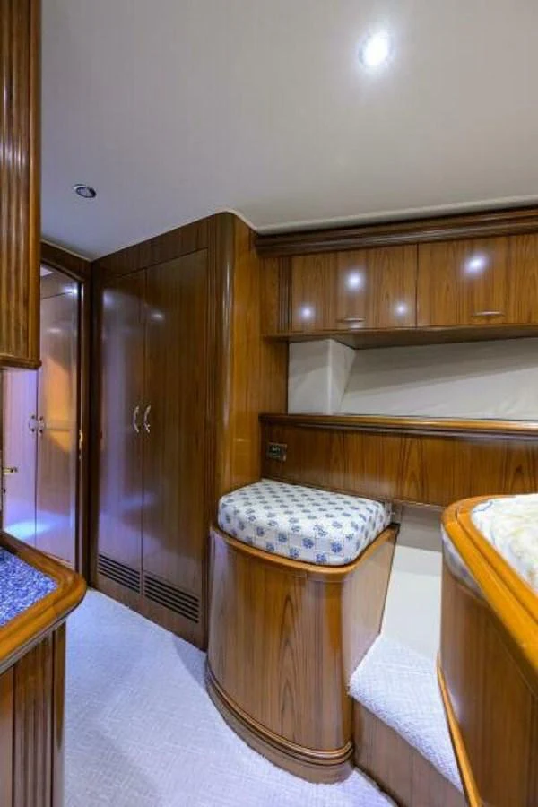 The yacht's interior features polished wooden cabinetry and cozy seating arrangements. aboard JUNIOR Yacht for Sale