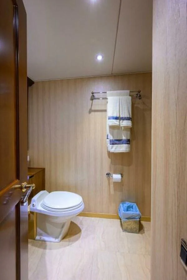 A well-appointed bathroom with modern fixtures and wooden accents. aboard JUNIOR Yacht for Sale