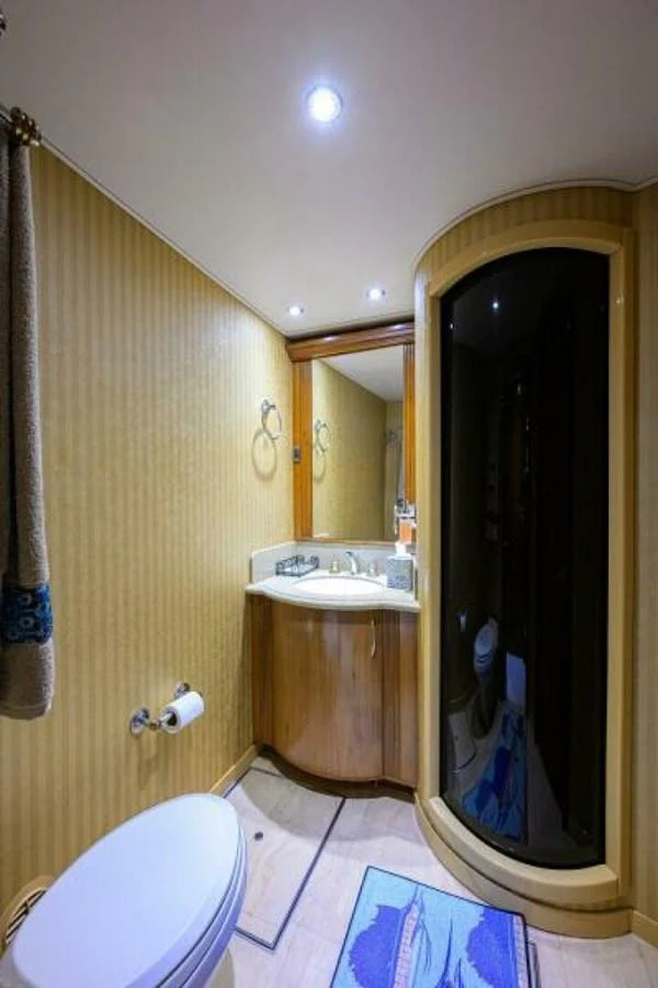 The yacht's bathroom features a modern shower and elegant fixtures. aboard JUNIOR Yacht for Sale