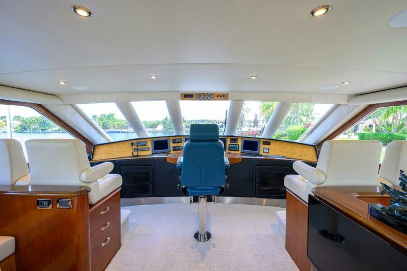 The helm station features a luxurious and spacious design with comfortable seating and advanced navigation equipment. aboard JUNIOR Yacht for Sale