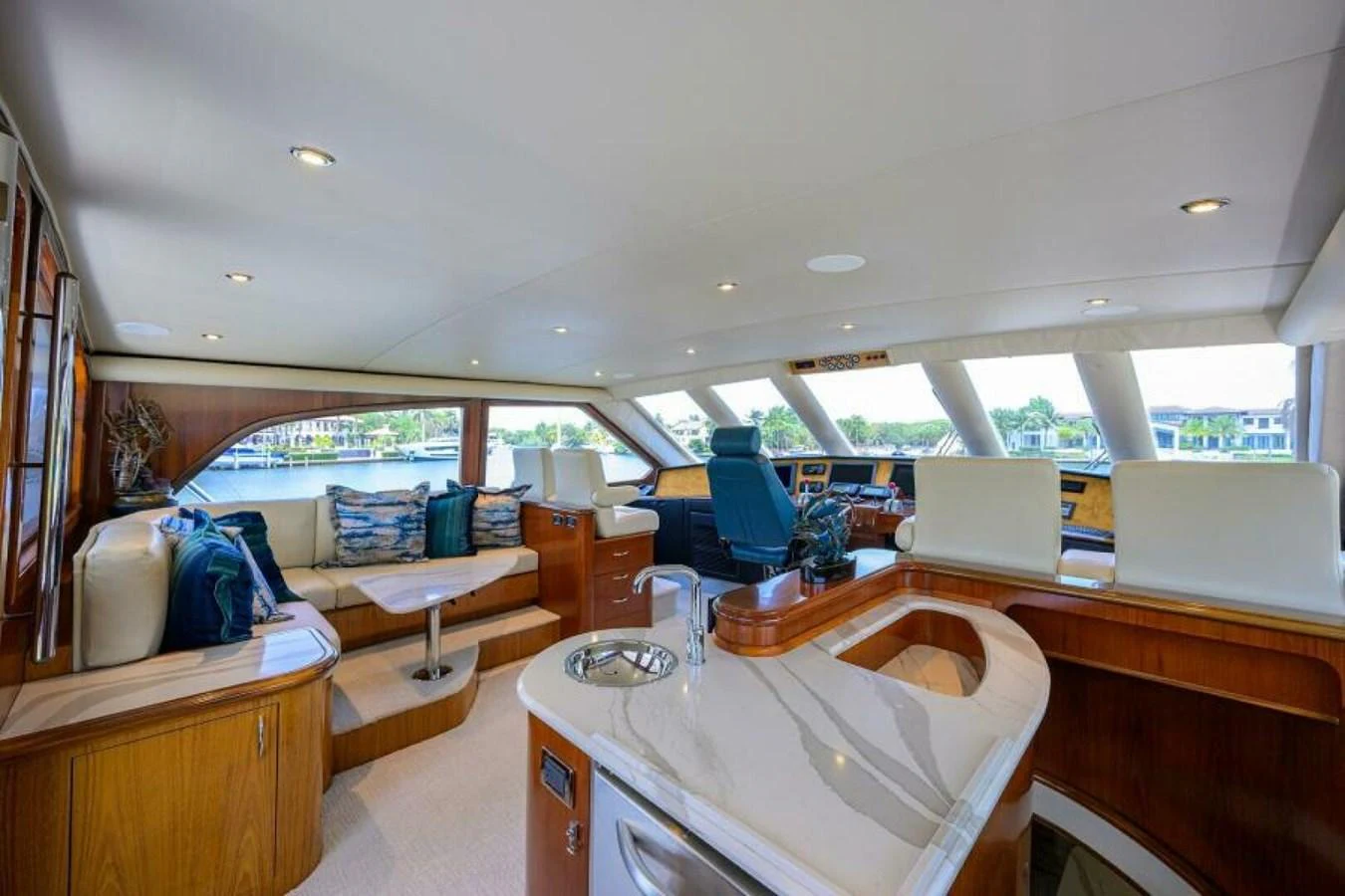The yacht's helm area features a spacious and luxurious interior with ample seating and a modern control station. aboard JUNIOR Yacht for Sale