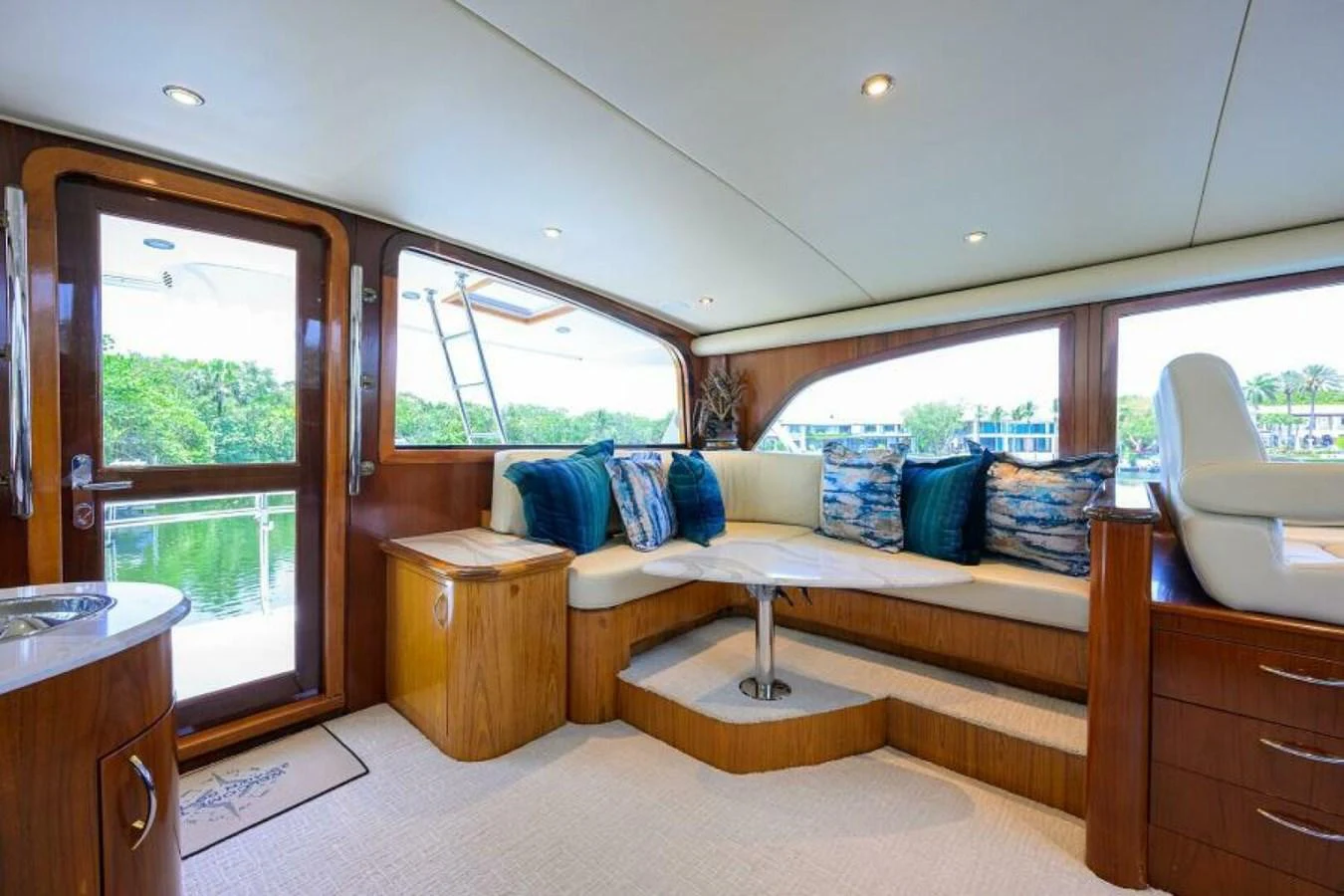 The salon offers a cozy and inviting space with plush seating and large windows for natural light. aboard JUNIOR Yacht for Sale