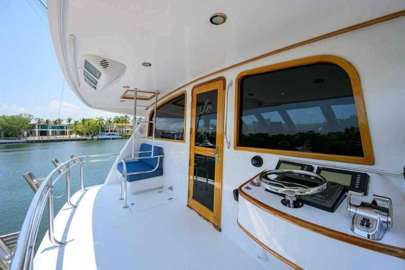 The aft deck offers a serene space with a helm station and comfortable seating, perfect for enjoying the view. aboard JUNIOR Yacht for Sale