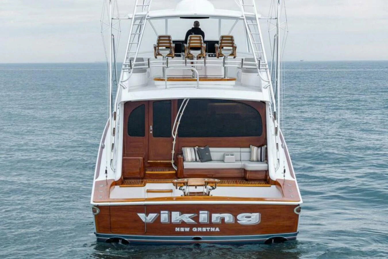 The yacht's aft deck features a spacious seating area and a sleek design, perfect for enjoying the open sea. aboard 2027 VIKING 82C Yacht for Sale