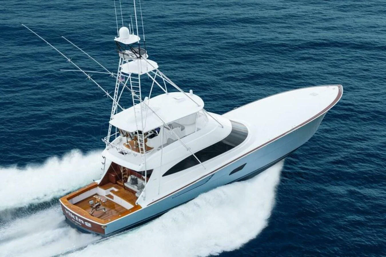 A sleek yacht cruises swiftly across the open sea, showcasing its elegant design and powerful performance. aboard 2027 VIKING 82C Yacht for Sale