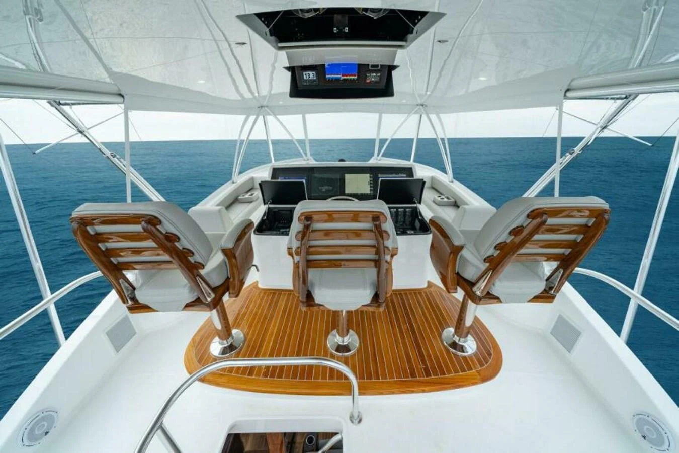 The helm station features luxurious seating and state-of-the-art navigation equipment, offering a commanding view of the open sea. aboard 2027 VIKING 82C Yacht for Sale
