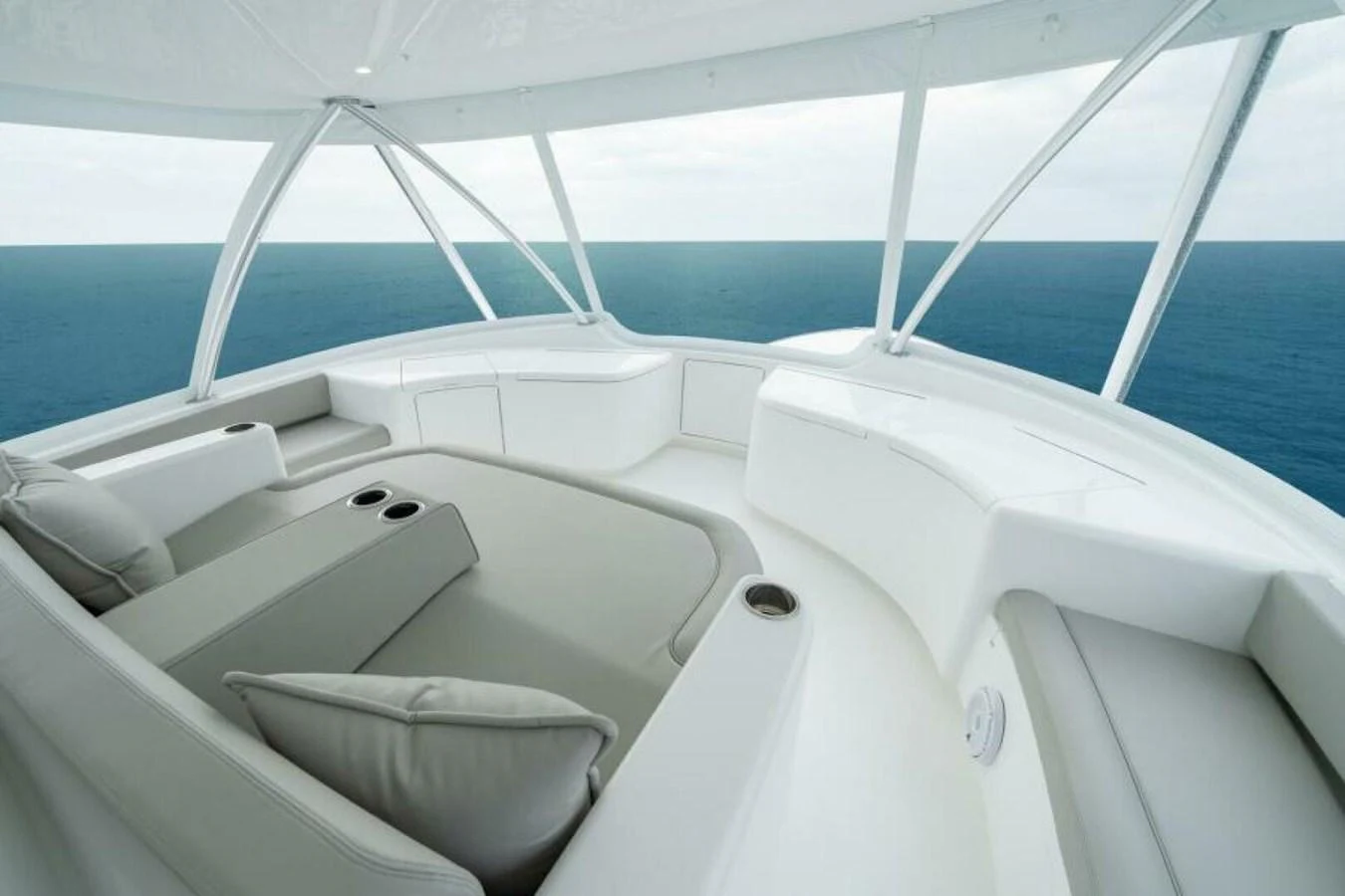 The flybridge offers a serene and spacious seating area with panoramic ocean views. aboard 2027 VIKING 82C Yacht for Sale