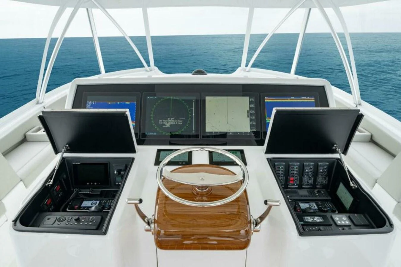 The yacht's helm features advanced navigation equipment and a sleek, modern design. aboard 2027 VIKING 82C Yacht for Sale