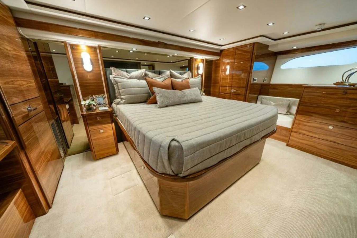 The master stateroom features luxurious wood paneling and a plush bed, creating a warm and inviting atmosphere. aboard 2027 VIKING 82C Yacht for Sale