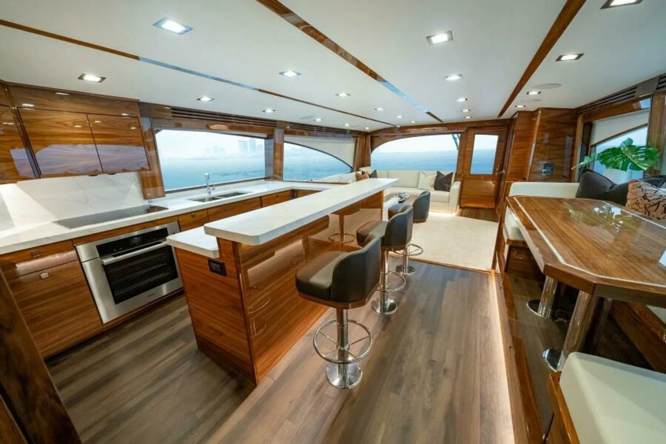 The yacht's galley features modern appliances, sleek wooden cabinetry, and a spacious layout. aboard 2027 VIKING 82C Yacht for Sale