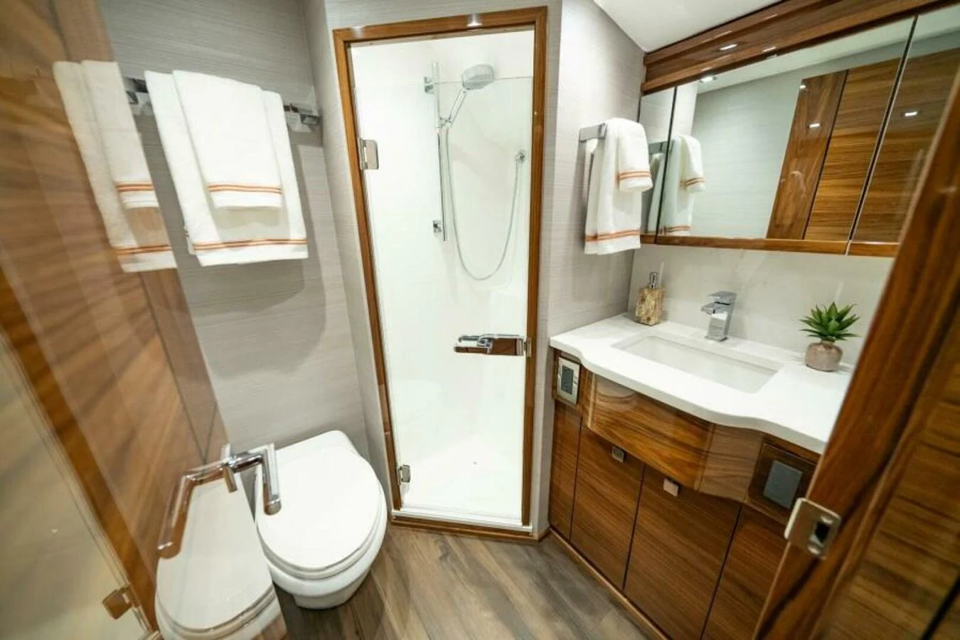 The yacht's bathroom features a sleek design with modern fixtures and ample storage. aboard 2027 VIKING 82C Yacht for Sale