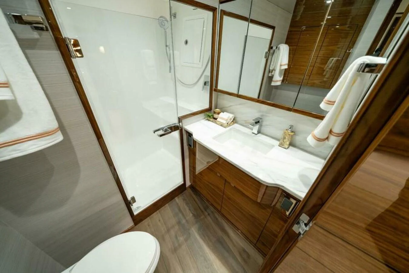 The yacht's bathroom features a sleek design with modern fixtures and ample storage. aboard 2027 VIKING 82C Yacht for Sale