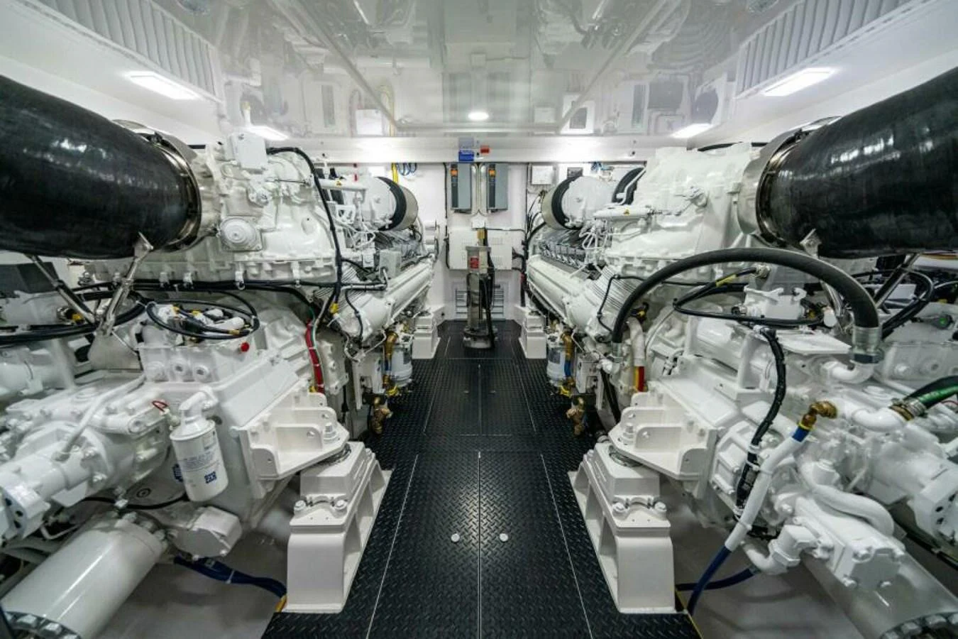 The engine room showcases powerful and meticulously maintained machinery. aboard 2027 VIKING 82C Yacht for Sale