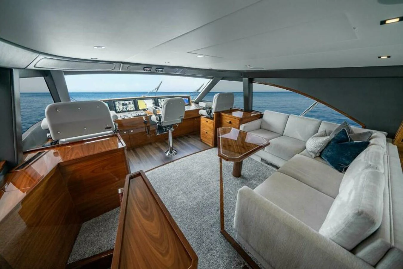 The yacht's helm area features luxurious seating and state-of-the-art navigation equipment, complemented by a comfortable lounge space. aboard 2027 VIKING 82SB Yacht for Sale
