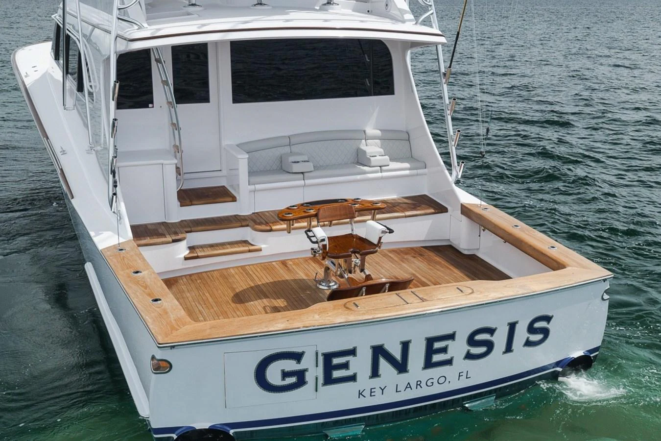 The yacht's aft deck features a spacious area with comfortable seating and a fishing chair, perfect for leisure and sport. aboard GENESIS Yacht for Sale