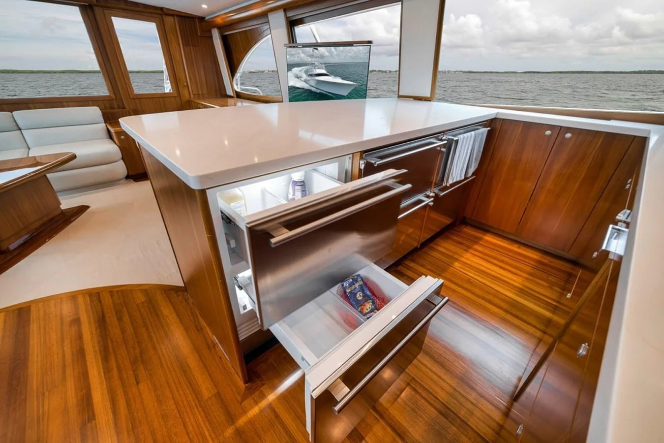The galley features modern appliances and elegant wood finishes, offering a luxurious space for meal preparation. aboard GENESIS Yacht for Sale