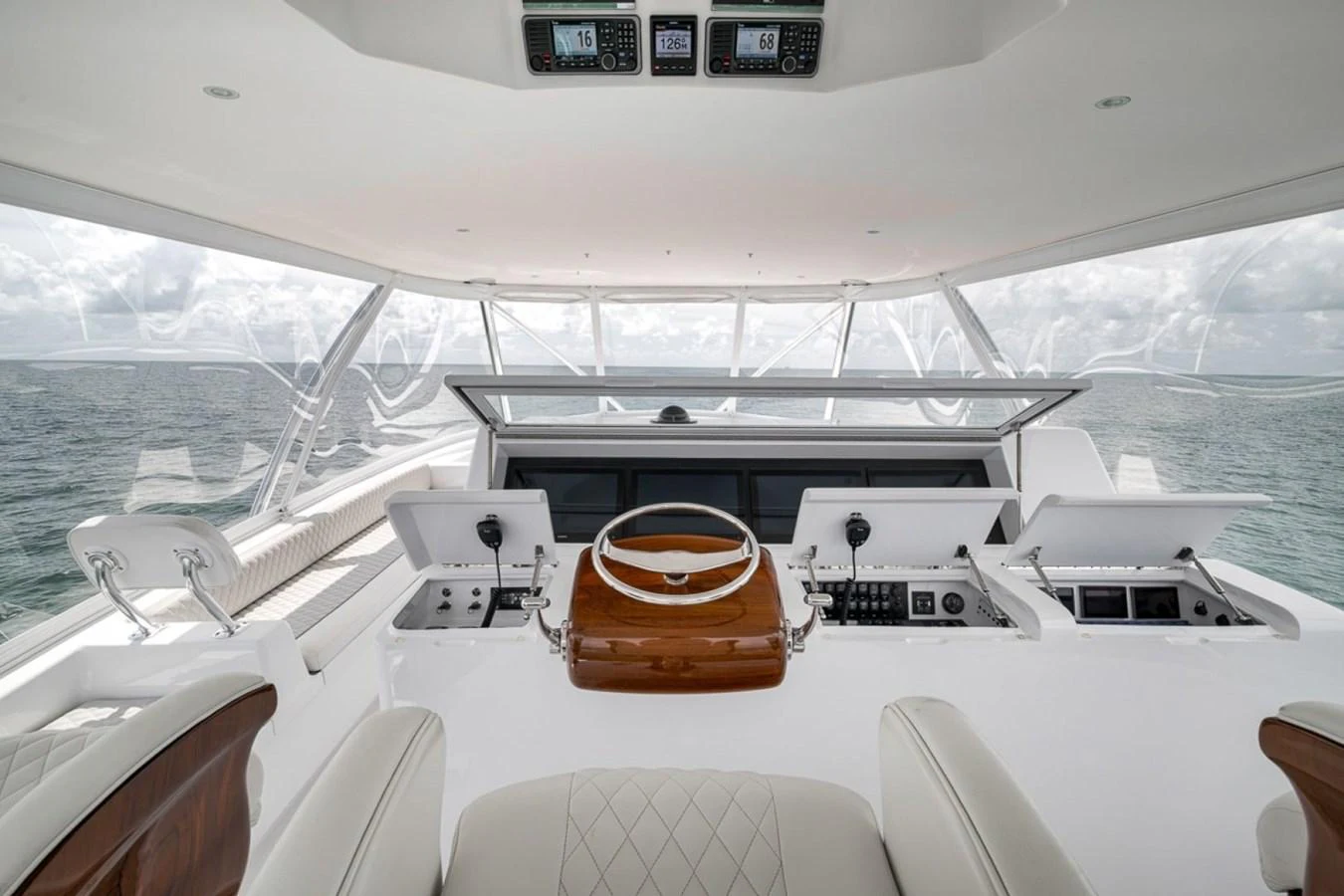 The helm station features a sleek, modern design with advanced navigation equipment and luxurious seating. aboard GENESIS Yacht for Sale