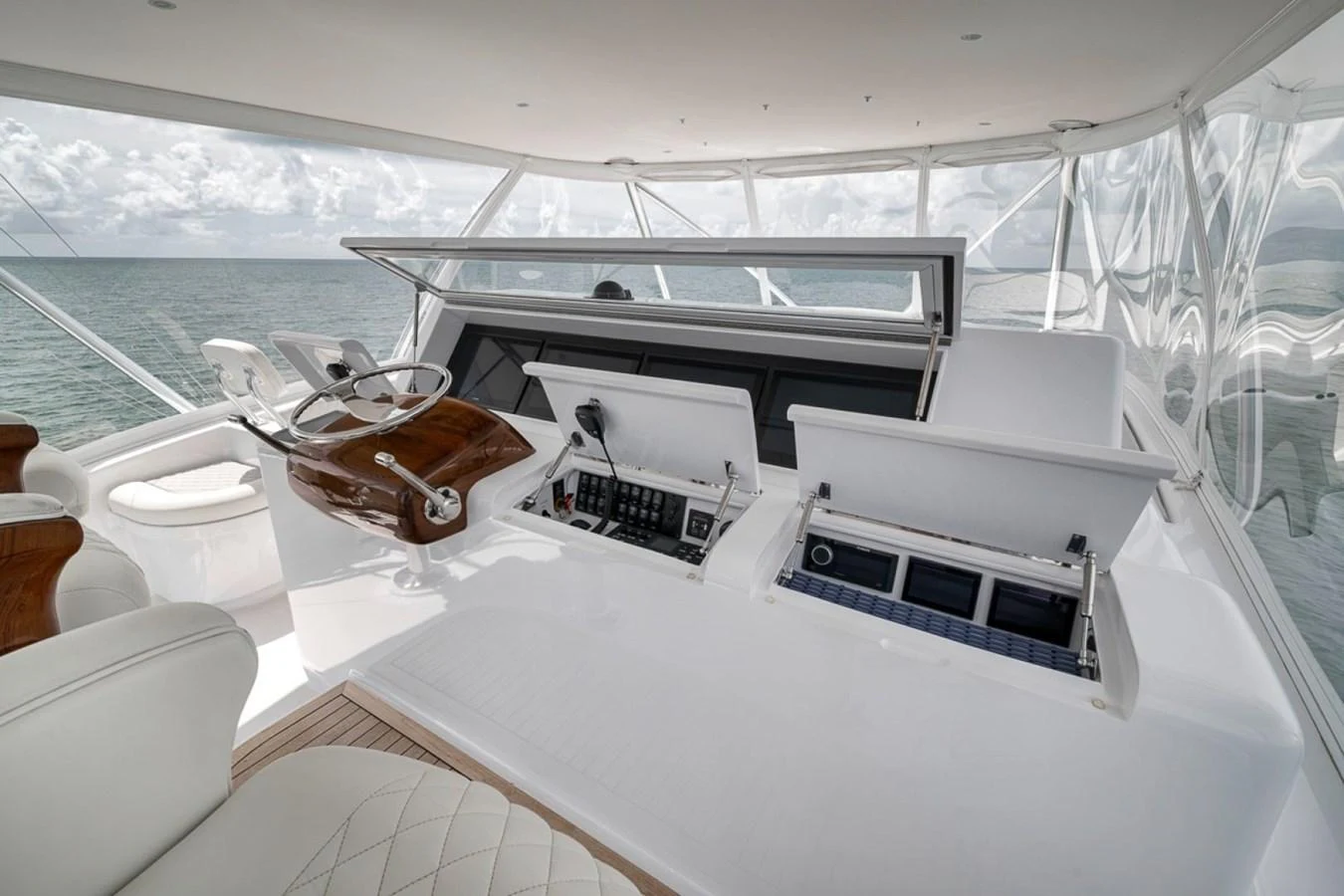 The helm station offers a sleek and modern control area with advanced navigation equipment and comfortable seating. aboard GENESIS Yacht for Sale