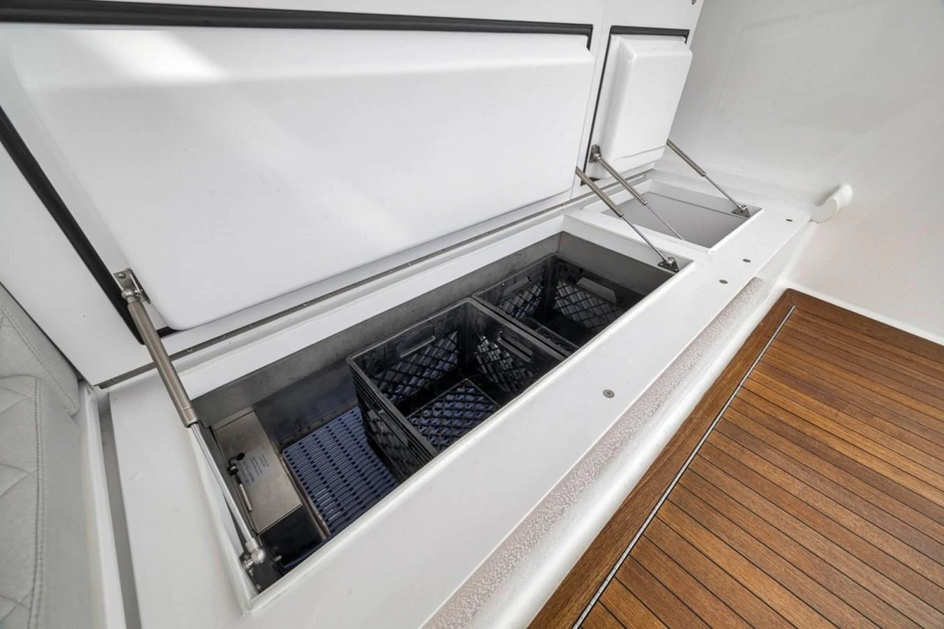A detailed view of a storage compartment with organized bins on a yacht. aboard GENESIS Yacht for Sale