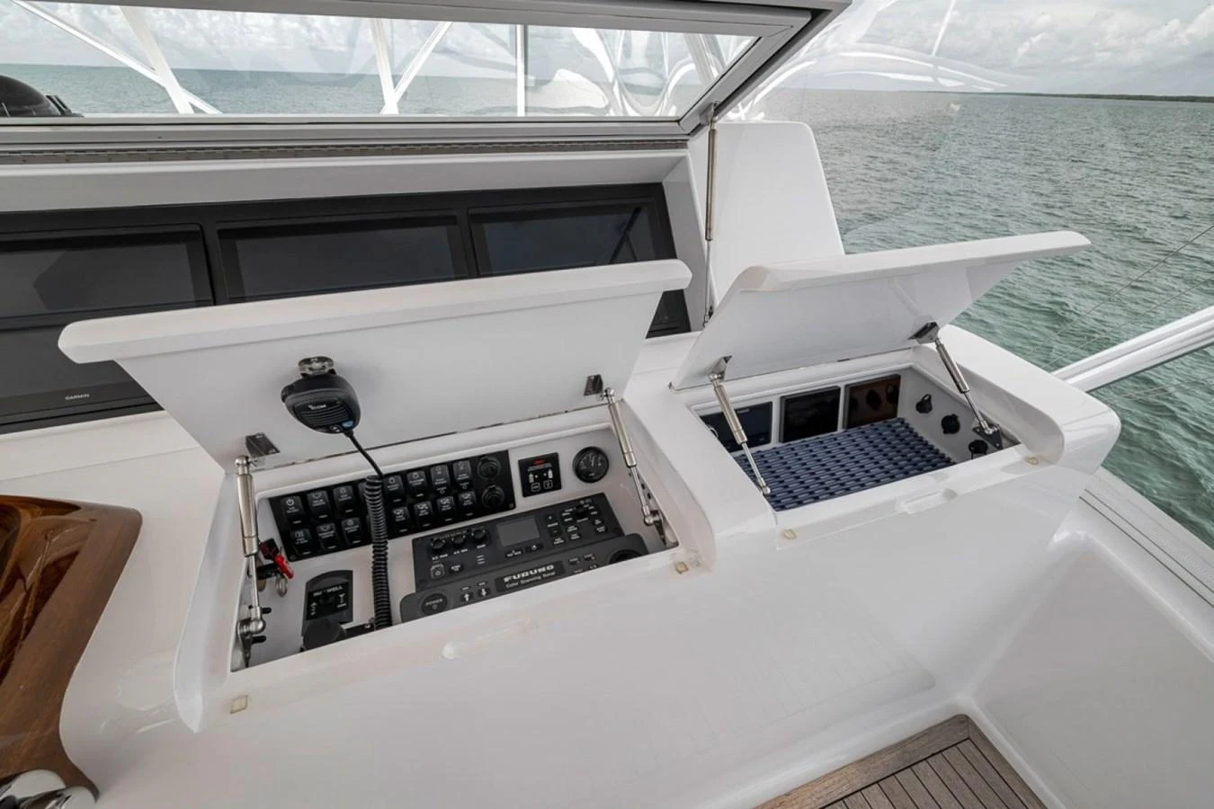 The helm station features advanced navigation and control systems with neatly organized compartments. aboard GENESIS Yacht for Sale